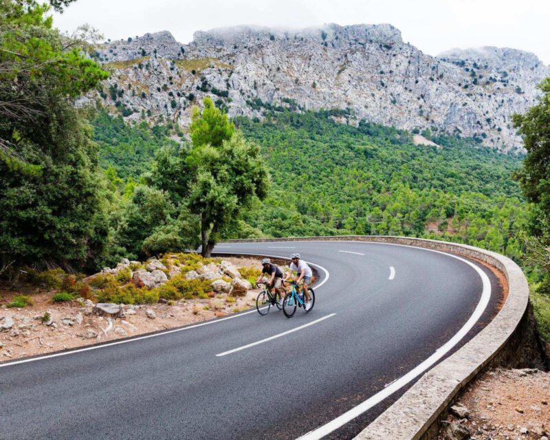 Two cyclists riding up the Puig Major peak in Majorca