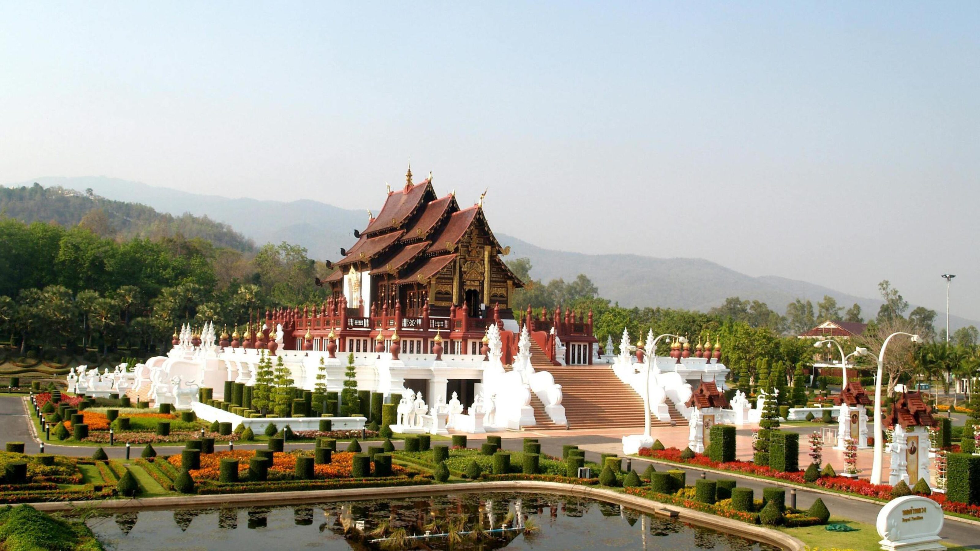 Traditional Thai architecture of the Royal Pavilion surrounded by formal gardens and mountains in Chiang Mai.