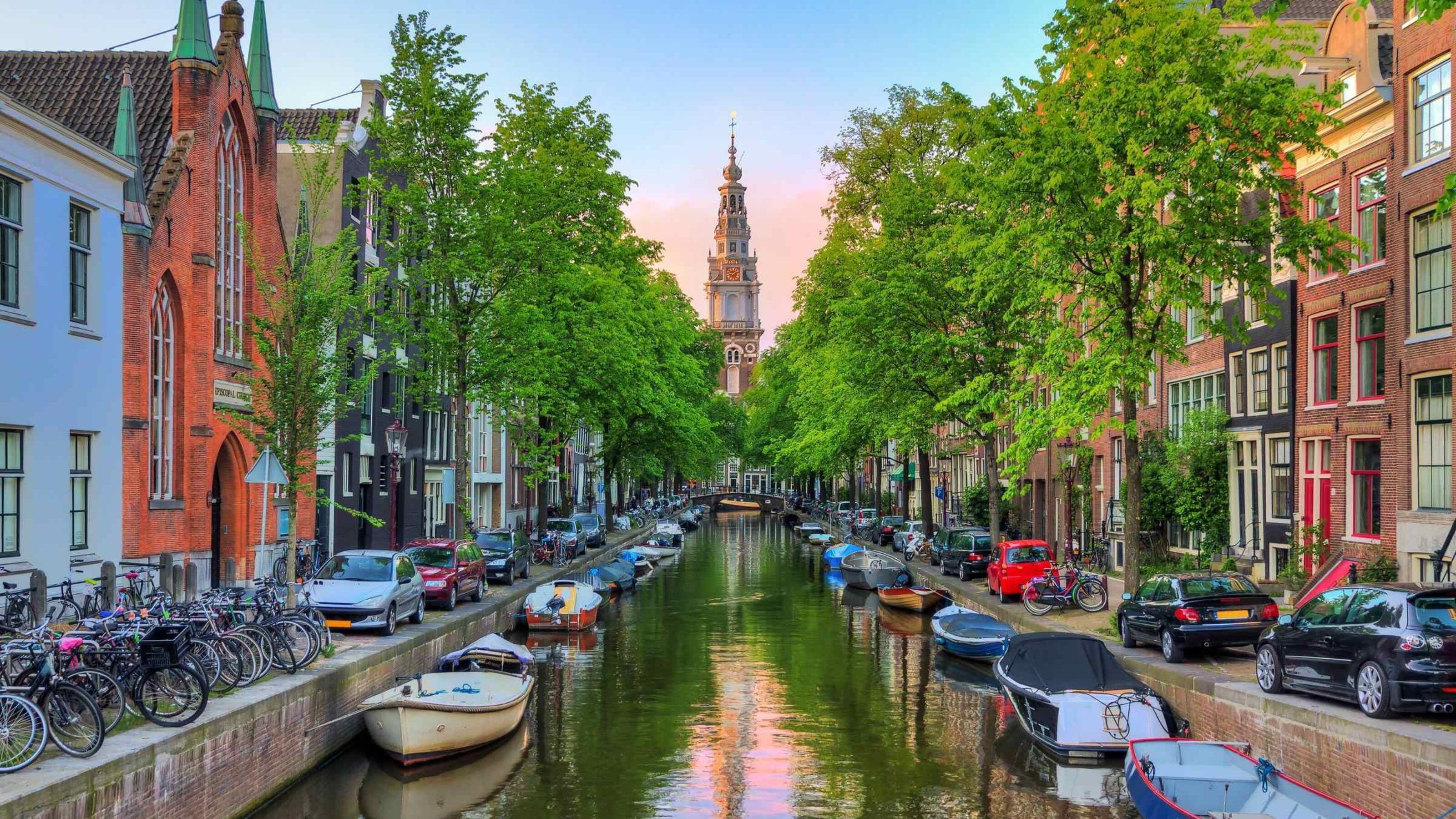 The Groenburgwal canal in Amsterdam with the Soutern church (Zuiderkerk) at sunset in the summer.