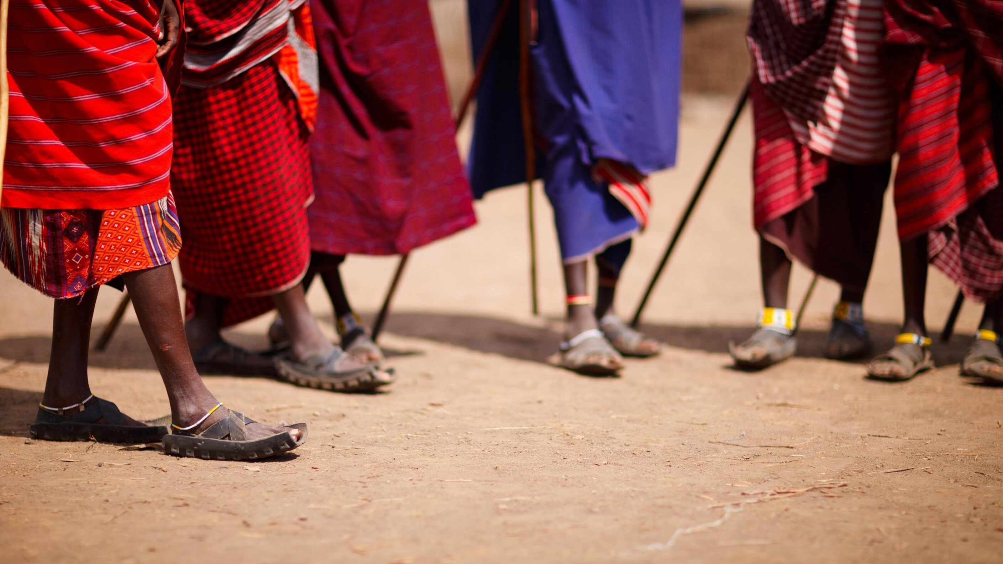 Close up picture of Maasai warriors wearing red and blue robes