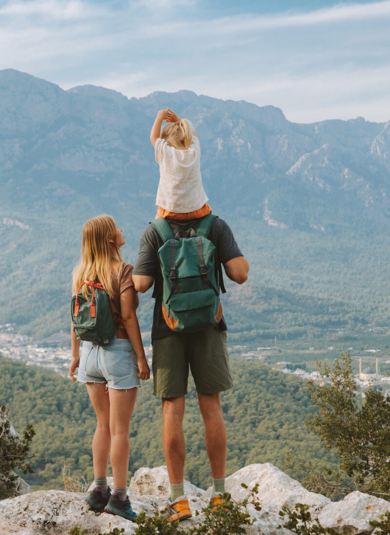 Family hiking parents with child outdoor travel in mountains active vacations lifestyle mother and father backpacking together with baby in Turkey