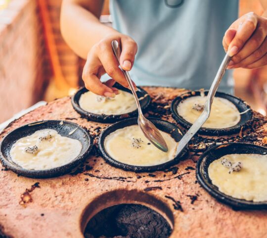 Taste crisp Vietnamese pancakes, cooked fresh from the pan and typically filled with pork, prawns and beansprouts.