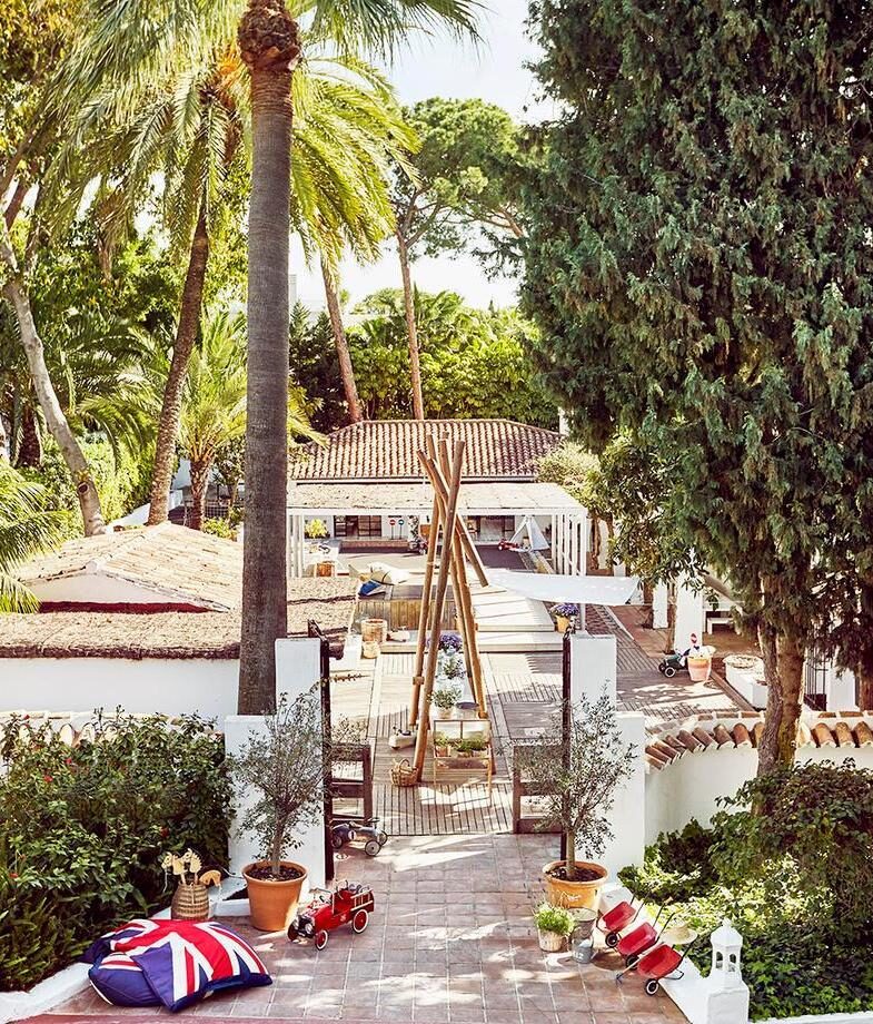 The outdoor kids’ club at Marbella Club Hotel and the elegant lounge area of Hotel Alfonso XIII showcasing its traditional Mudéjar architecture.