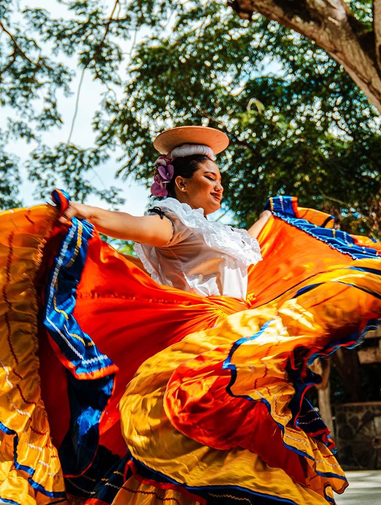A traditional Guanacaste dancer in Costa Rica twirls beautiful vibrant clothing.
