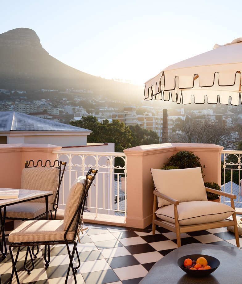 The sunlit terrace with mountain views over Cape Town at Mount Nelson Hotel, and the bright family villa dining room opening onto a small pool terrace at Cape Cadogan Residence.
