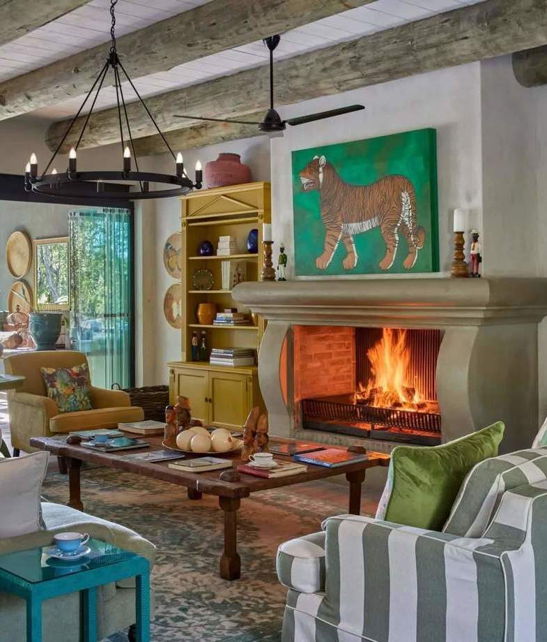 The firelit family lounge at Royal Malewane Waterside House, and one of the private safari suites with a deck and plunge pool at Pioneer Camp.
