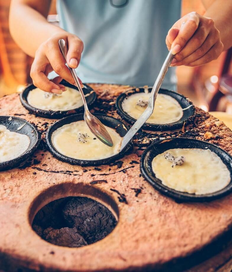 Get closer to Vietnamese culture by trying crafts in Hoi An or street food in Hanoi