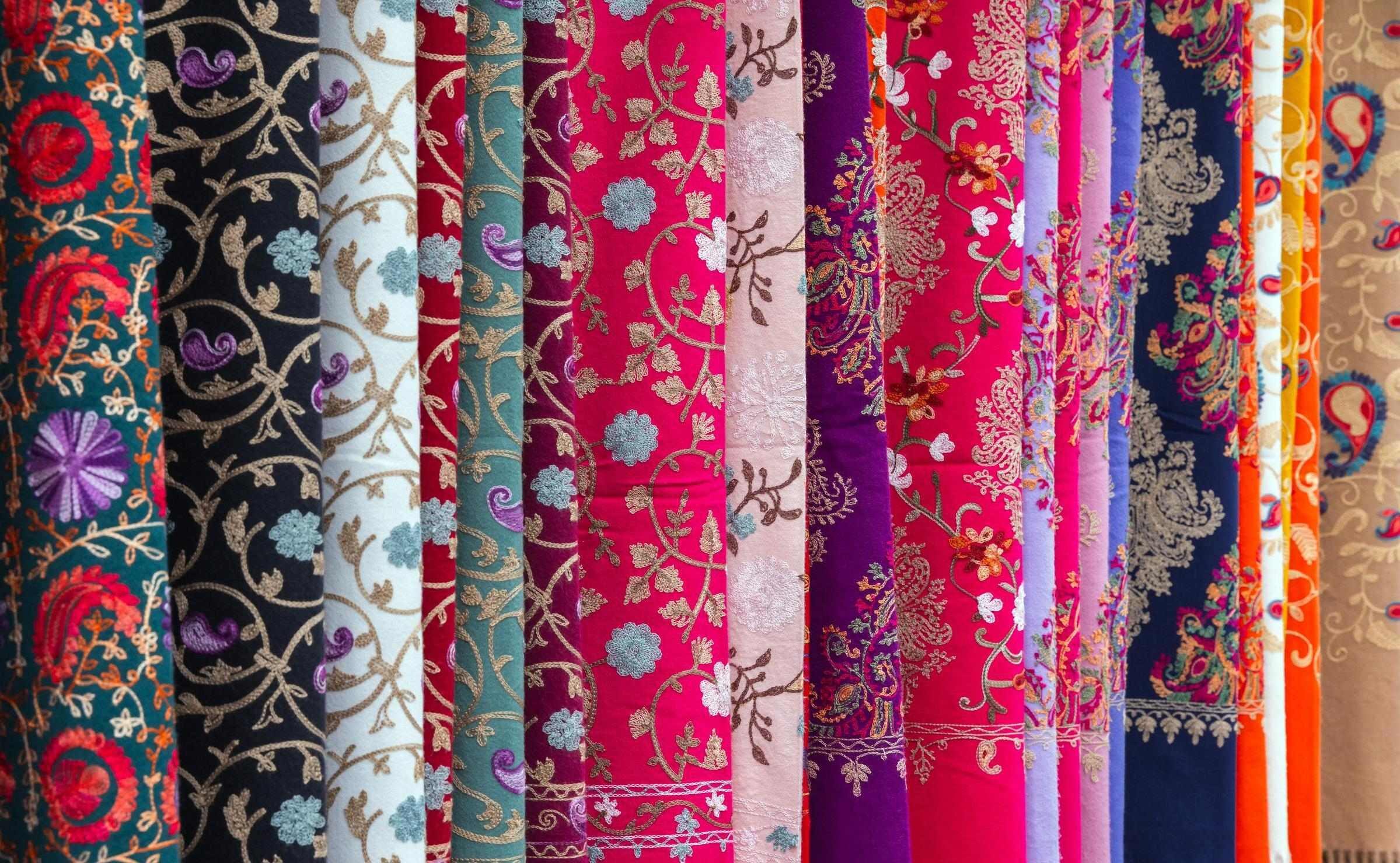 close up of intricately patterned colourful fabrics hanging up on display in Baku, Azerbaijan