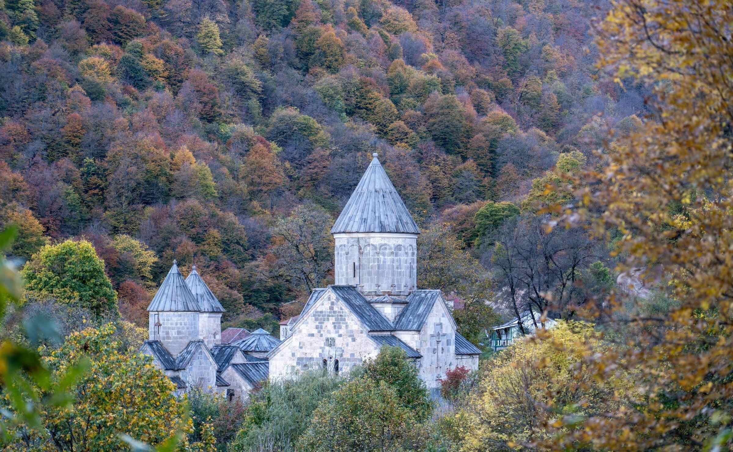 A monastery surrounded by autumn foliage in Dilijan, Armenia