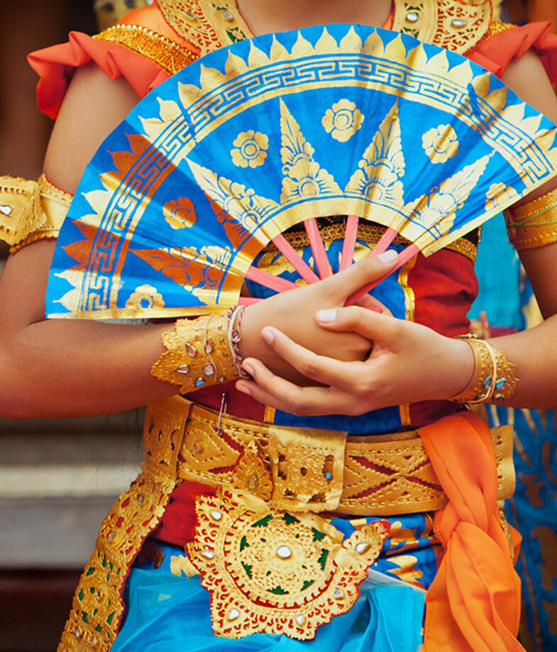 The tracks of Maeklong Railway Market in Thailand and Balinese dancers in traditional dress.