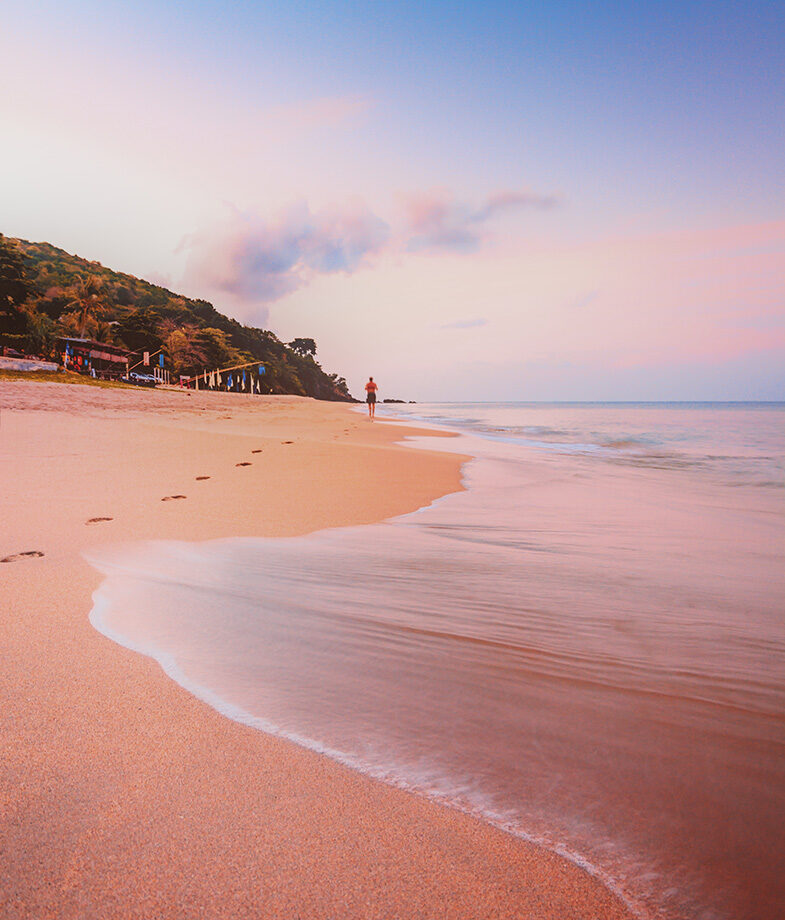A lush green trail in Cuc Phuong National Park in Vietnam and Koh Lanta beach in Thailand at sunset.