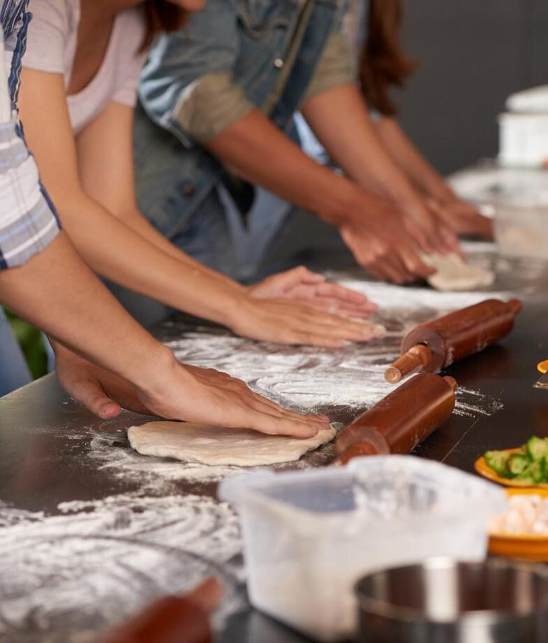 Engage in traditional cuisine with a tea ceremony in Japan or a pizza making workshop in Italy