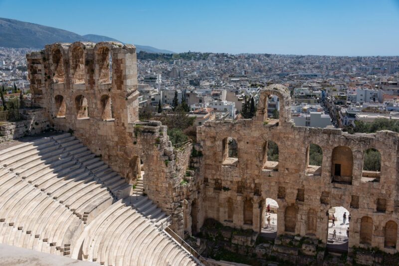 The Odeon of Herodes Atticus ancient stone theatre with its arches and tiered seating overlooking the city of Athens, Greece.