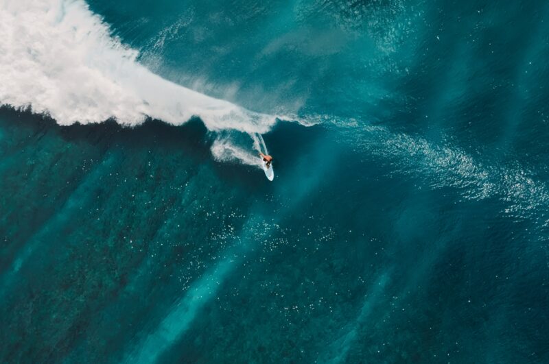 Aerial view of a person surfing a wave