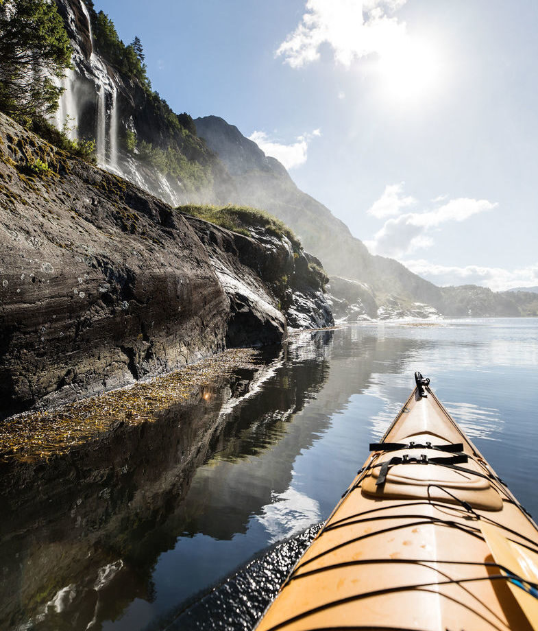 Kayak beneath cascading waterfalls in Norway’s Sunnfjord while staying at Åmot Gard. Enjoy the privacy of a secluded Finnish Arctic retreat, sharing coffee around an open fire amid snow-covered forests.