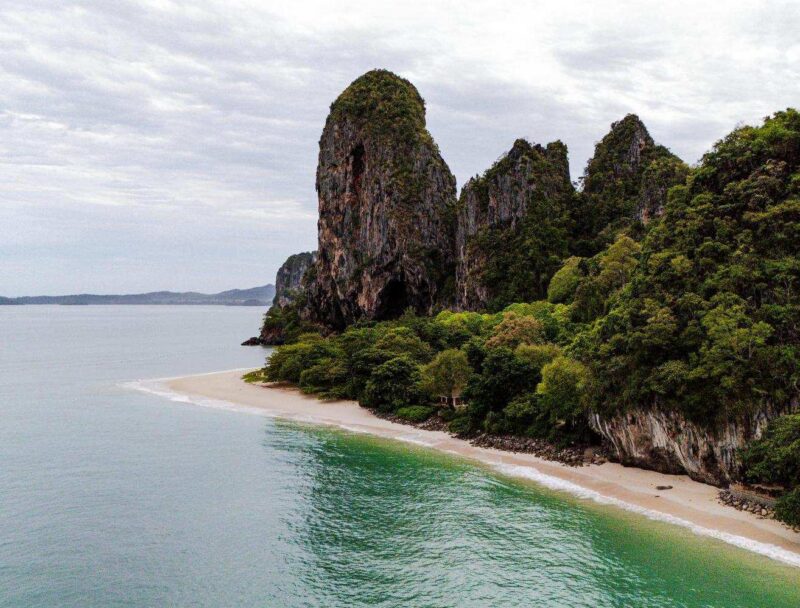Krabi's beach and coastline with towering limestone cliffs.